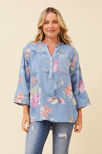 a light blue floral long-sleeve blouse with a button placket and 3/4 sleeves, paired with distressed blue jeans